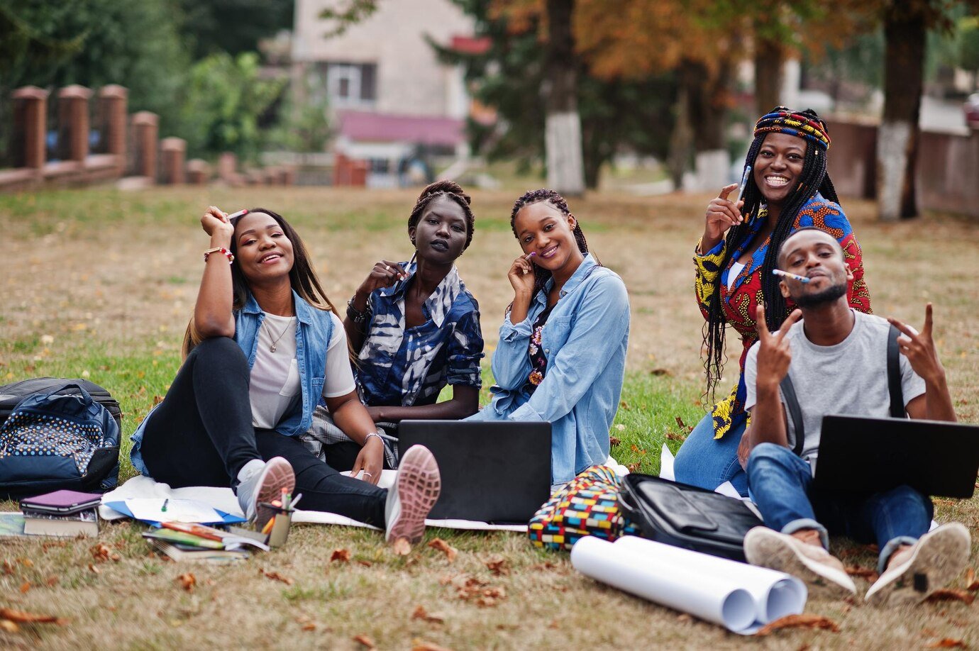 Students smiling in front of a Canadian university building in autumn